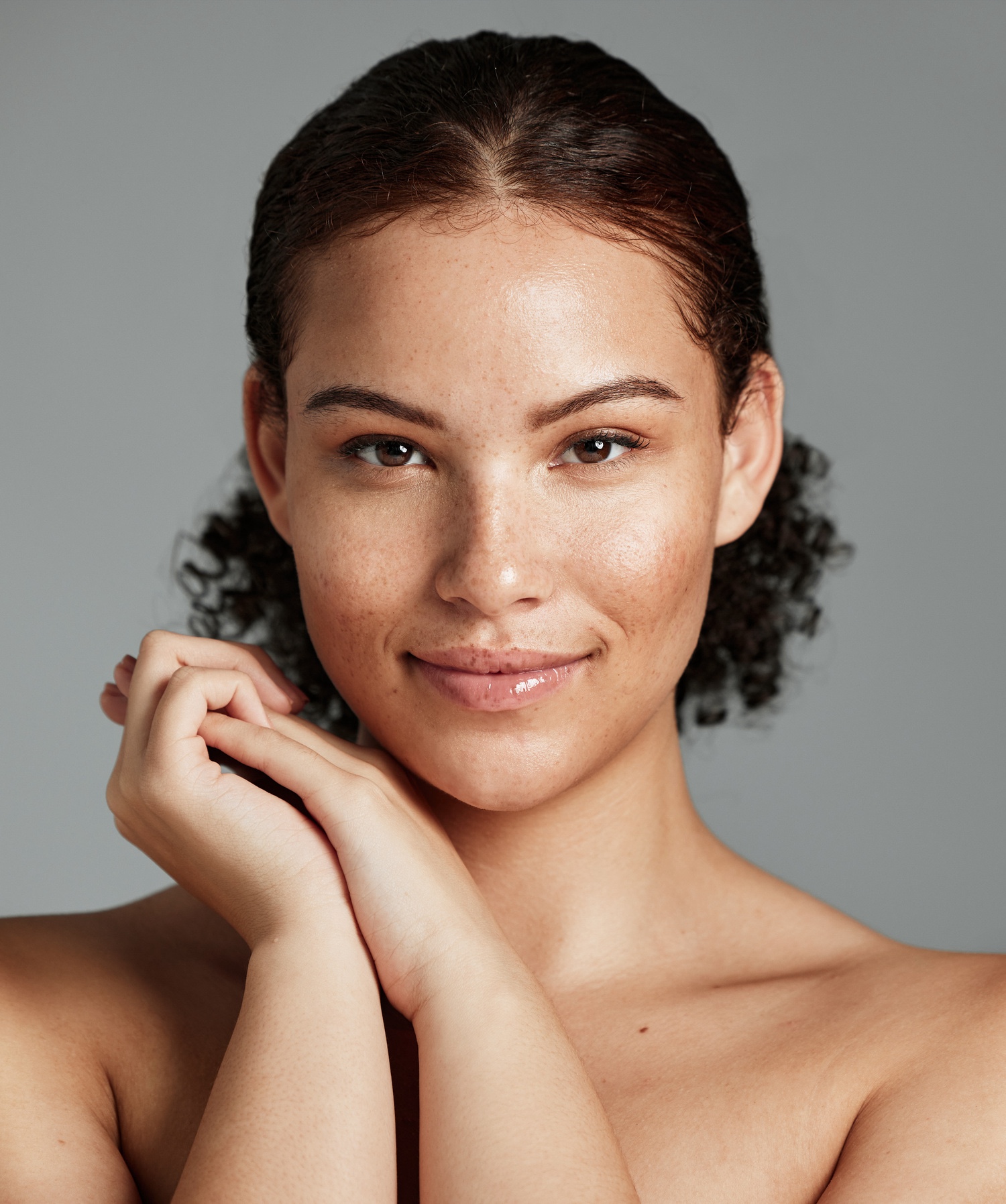 Photo of a brunette woman wearing a sweater