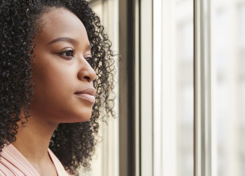 Serious-looking woman staring out the window