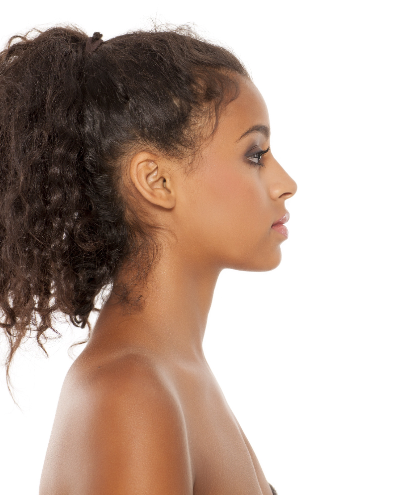 Side profile photo of a young woman with her hair up in a bun