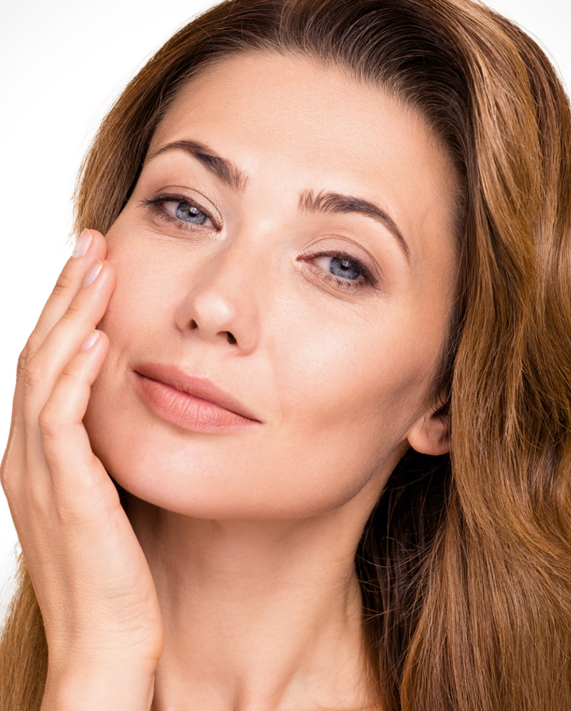 Brunette woman touching her face
