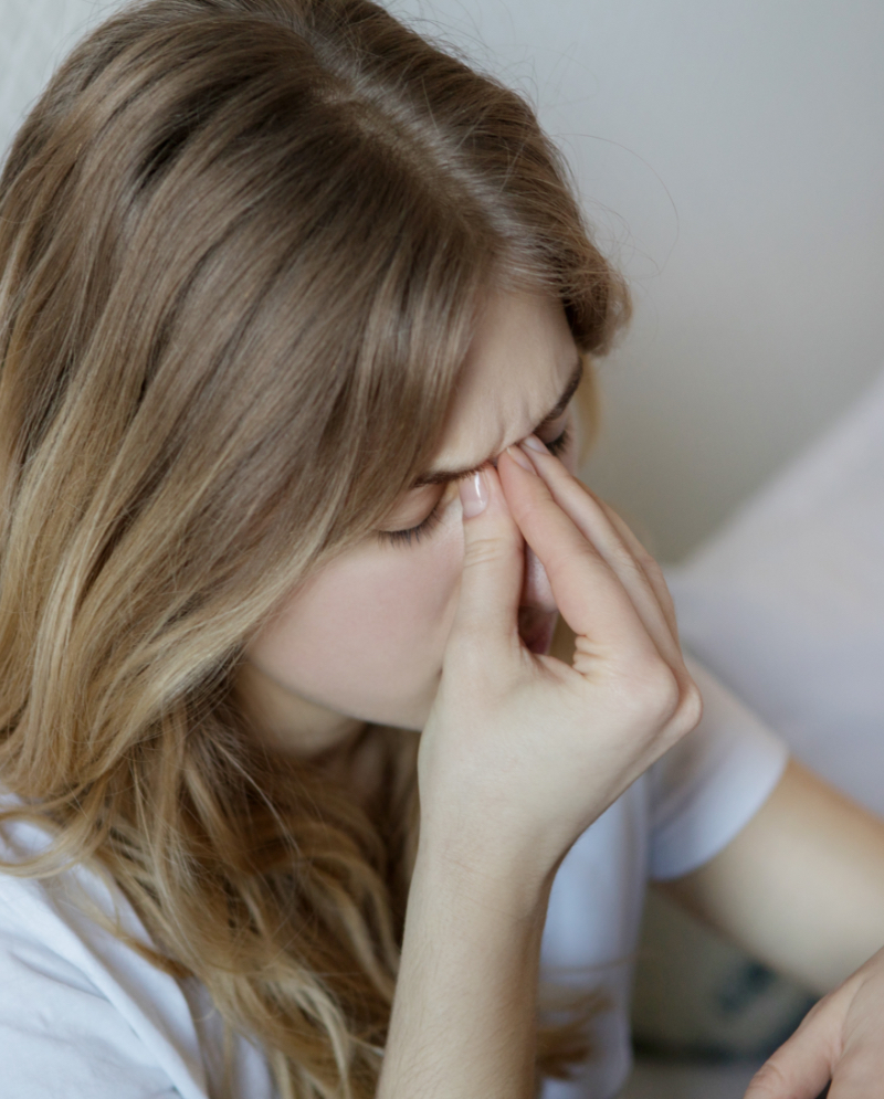 Woman pinching the bridge of her nose