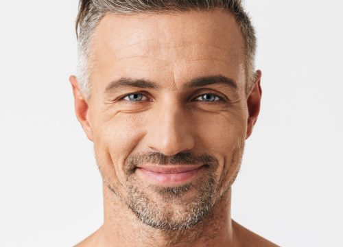 Close-up on a smiling middle-age man with good skin