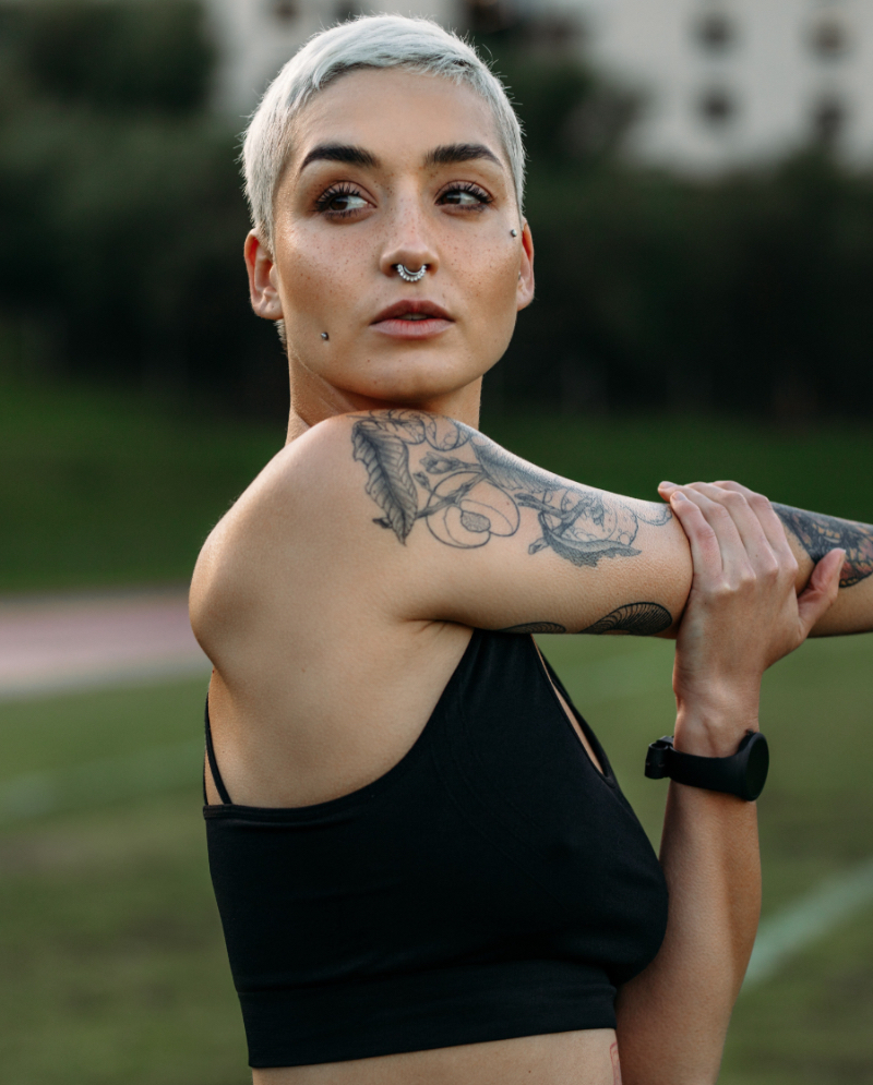 Woman with short, dyed hair and unwanted tattoos