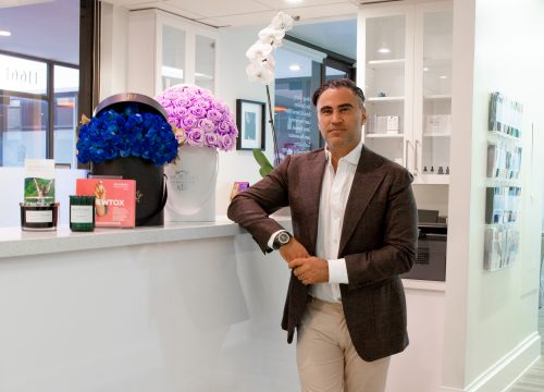 Dr. Kia standing by the front desk reception area